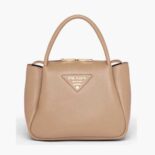 Prada Women Small leather handbag with the Prada Metal Lettering Logo Illuminating Its Center-sandy