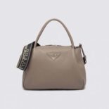 Prada Women Large Leather Handbag with the Prada Metal Lettering Logo Gleaming at Its Center-Brown